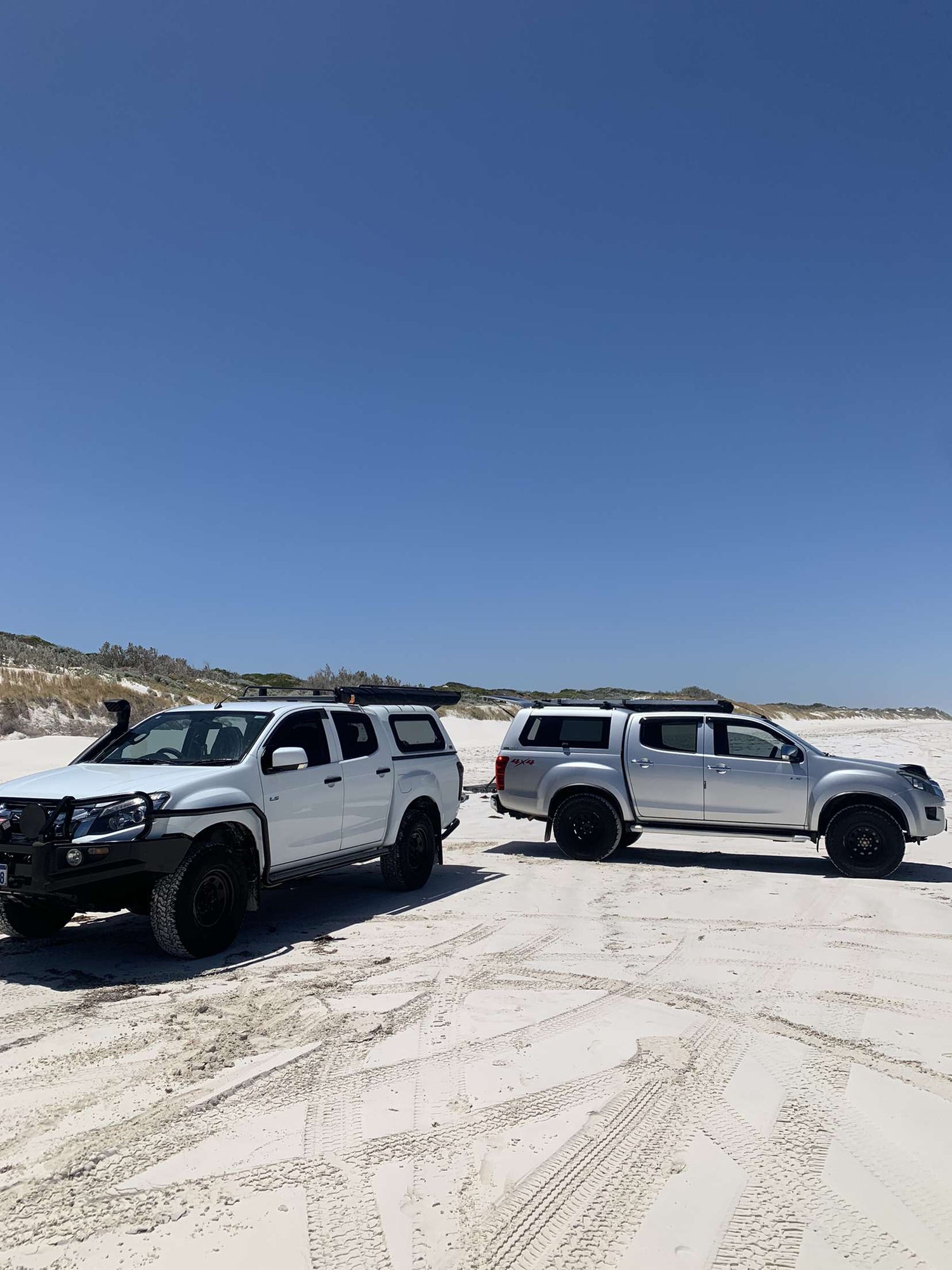 terretrac at a pristine beach with two d-max 4x4's fishing and camping