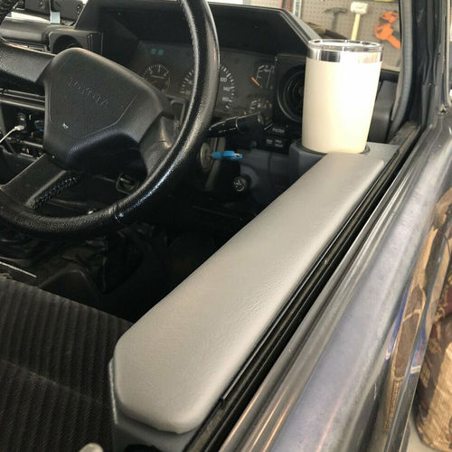 Armrest Cup Holder Magnet Door For Land Cruiser 70 Series shown snuggly holding a coffee cup